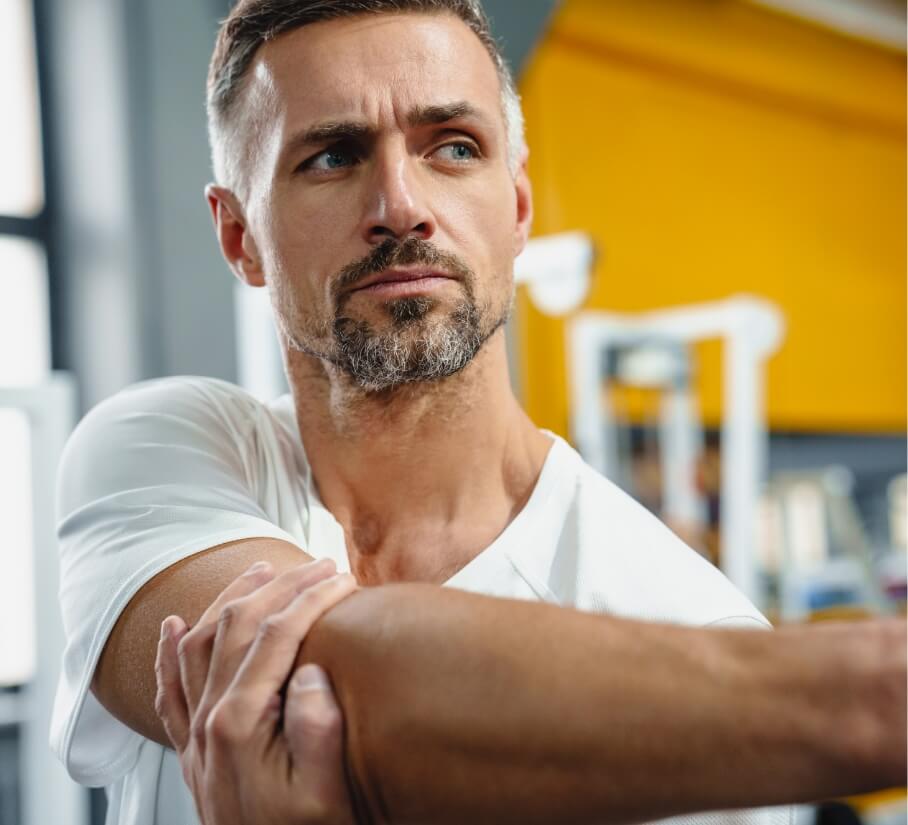 focused-grey-adult-sportsman-stretching-his-arm-wh-2023-11-27-05-20-45-utc (1)