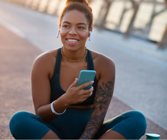 dark-skinned-smiling-woman-sitting-on-bridge-after-2024-10-18-03-19-47-utc (1)