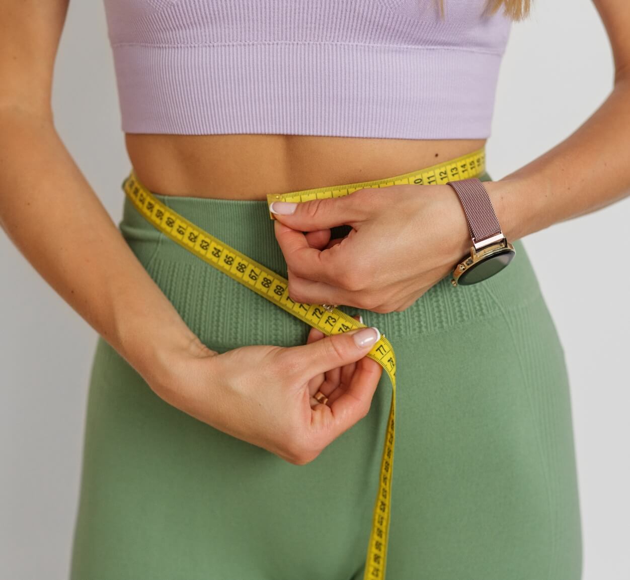 slim-woman-measuring-her-waist-by-measure-tape-cl-2023-11-27-05-08-12-utc-1